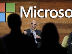 FILE - In this Wednesday, Nov. 30, 2016, file photo, Microsoft CEO Satya Nadella, center, answers a question from the audience at the annual Microsoft shareholders meeting as Brad Smith, left, president and chief legal officer, and Amy Hood, chief financial officer, look on, in Bellevue, Wash. As Microsoft begins to talk more about its ambitions in advancing the next stage of artificial intelligence, some see the company's Bing search engine as the overlooked foundation to those efforts. Nadella describes Bing as a "great training ground for building the hyper-scale, cloud-first services" that have allowed the company to pivot to new technologies as its computer software business wanes. (AP Photo/Elaine Thompson, File)