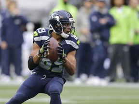 FILE - In this Nov. 20, 2016 file photo, Seattle Seahawks wide receiver Doug Baldwin gets set to pass to quarterback Russell Wilson for a touchdown against the Philadelphia Eagles in the second half of an NFL football game, in Seattle. (AP Photo/Stephen Brashear, File)