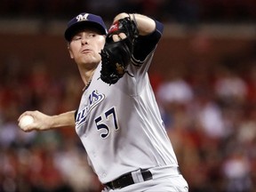 FILE - In this Sept. 29, 2017, file photo, Milwaukee Brewers starting pitcher Chase Anderson throws during the first inning of a baseball game against the St. Louis Cardinals in St. Louis. The Brewers have signed Anderson to a two-year contract through the 2019 season, with club options for 2020 and 2021. The 29-year-old right-hander was eligible for arbitration. (AP Photo/Jeff Roberson, File)