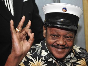FILE - In this Nov. 5, 2008 file photo, Fats Domino waves to fans before a ceremony re-presenting two Grammy awards to replace the ones that he lost from Hurricane Katrina's flooding in New Orleans. Domino, the amiable rock 'n' roll pioneer whose steady, pounding piano and easy baritone helped change popular music even as it honored the grand, good-humored tradition of the Crescent City, has died. He was 89. Mark Bone, chief investigator with the Jefferson Parish, Louisiana, coroner's office, said Domino died Tuesday, Oct. 24, 2017.  (AP Photo/Cheryl Gerber)