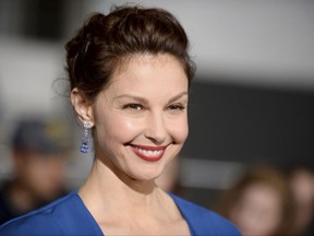 FILE - In this March 18, 2014, file photo, Ashley Judd arrives at the world premiere of "Divergent" at the Westwood Regency Village Theater in Los Angeles.   ABC News says Judd will sit down with anchor Diane Sawyer for her first television interview since the actress-activist went public with allegations against movie executive Harvey Weinstein. The interview will air Thursday on ABC News platforms. (Photo by Jordan Strauss/Invision/AP, File)