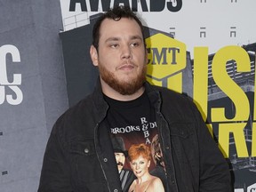 FILE - In this June 7, 2017 file photo, Luke Combs arrives at the CMT Music Awards in Nashville, Tenn. Combs took to social media to express his sadness after the mass shooting Sunday, Oct. 1, in Las Vegas at the Route 91 Harvest Festival. He performed earlier in the evening. (Photo by Sanford Myers/Invision/AP, File)