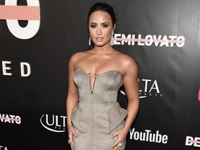 FILE - In this Oct. 11, 2017 file photo, Demi Lovato arrives at the premiere of her documentary, "Demi Lovato: Simply Complicated" in Los Angeles. In the film, Lovato spills the beans about her years of drug abuse, her eating disorder and even the time she angrily punched one of her backup dancers in the face. (Photo by Chris Pizzello/Invision/AP, File)