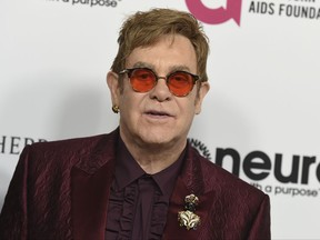 FILE - In this March 25, 2017 file photo, Elton John arrives at Elton John's 70th Birthday and 50-Year Songwriting Partnership with Bernie Taupin celebration in Los Angeles. John announced Monday, Oct. 16, 2017, that his show, "The Million Dollar Piano" at Caesars Palace in Las Vegas will be ending in May 2018 after more than 200 performances. (Photo by Jordan Strauss/Invision/AP, File)