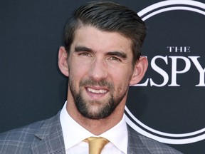 FILE - In this July 12, 2017 file photo, Olympic swimmer Michael Phelps arrives at the ESPYS in Los Angeles. Phelps appears in the documentary, "Angst" to share his story of being bullied and depressed. (Photo by Jordan Strauss/Invision/AP, File)