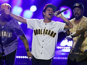 FILE - In this Sunday, June 25, 2017, file photo, Bruno Mars performs "Perm" at the BET Awards at the Microsoft Theater in Los Angeles. Mars is the top nominee with eight nods at the American Music Awards, while The Chainsmokers, Drake, Kendrick Lamar, Ed Sheeran and The Weeknd all earned five nominations each. The show will broadcast live from the Microsoft Theater in Los Angeles on Nov. 19 at 8:00 p.m. Eastern on ABC.  (Photo by Matt Sayles/Invision/AP, File)