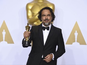 FILE - In this Feb. 28, 2016 file photo, Alejandro G. Inarritu poses in the press room with the award for best director for "The Revenant" at the Oscars in Los Angeles. Inarritu's groundbreaking virtual reality installation "CARNE y ARENA (Virtually Present, Physically Invisible)," will be awarded a special Oscar for its visionary and powerful storytelling. The Board of Governors of the Academy of Motion Picture Arts and Sciences said Friday, Oct. 27, 2017, that the Oscar statuette will be presented at the film academy's 9th annual Governor's Awards in Los Angeles on Nov. 11. (Photo by Jordan Strauss/Invision/AP, File)