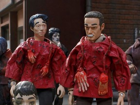 This image released by Adult Swim shows "The Walking Dead," characters Glenn, left, and Rick, in a parody of the series on "Robot Chicken," airing Sunday at midnight. (Adult Swim via AP)