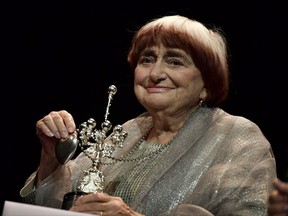 FILE - In this Sept. 24, 2017 file photo, film director Agnes Varda holds the Donostia Award for her contribution to the cinema at the 65th San Sebastian Film Festival, in San Sebastian, northern Spain. Varda reflects on her life in cinema, her status as a trailblazer for female filmmakers and the lifetime achievement award she'll receive from the Academy Awards. (AP Photo/Alvaro Barrientos, File)