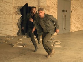 This image released by Warner Bros. Pictures shows Ryan Gosling, left, and Harrison Ford in a scene from "Blade Runner 2049." (Stephen Vaughan/Warner Bros. Pictures via AP)