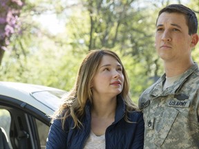 This image released by DreamWorks Pictures shows Haley Bennett, left, and Miles Teller in a scene from,"Thank You for Your Service." The drama follows a group of U.S. soldiers returning from Iraq who struggle to integrate back into family and civilian life. (Francois Duhamel/DreamWorks Pictures via AP)