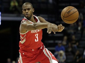 FILE - In this Oct. 11, 2017, file photo, Houston Rockets guard Chris Paul (3) passes against the Memphis Grizzlies in the first half of an NBA preseason basketball game in Memphis, Tenn. Paul had a new home in Los Angeles and the potential for a $200 million contract if he stayed with the Clippers. He also had reason to doubt a championship would ever come there. So he threw himself into the free agency process and ended up in Houston, the subject of a three-part documentary series titled "Chris Paul's Chapter 3" that debuts Thursday, Oct. 19, on ESPN. (AP Photo/Rogelio V. Solis, File)