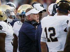 FILE - In this Sept. 16, 2017, file photo, Notre Dame head coach Brian Kelly stands with his team during the second half of an NCAA college football game against Boston College in Boston. No. 13 Notre Dame is 5-1 halfway through a crucial year for coach Kelley. Players say Kelley and the rest of the coaching staff became much more involved after last year's 4-8 debacle. (AP Photo/Michael Dwyer, File)
