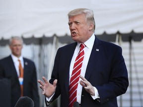 In this Oct. 7, 2017, photo, President Donald Trump speaks to reporters before leaving the White House in Washington for a brief stop at Andrews Air Force Base in Md., on his way to Greensboro, N.C. The Trump administration sent an immigration policy wish-list to Congress that includes overhauling the country's green-card system, hiring 10,000 more immigration officers and building a wall along the southern border. (AP Photo/Manuel Balce Ceneta)