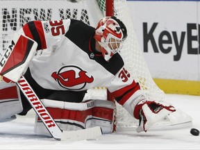 New Jersey Devils goalie Cory Schneider (35) covers the puck during the first period of an NHL hockey game against the Buffalo Sabres, Monday Oct. 9, 2017, in Buffalo, N.Y. (AP Photo/Jeffrey T. Barnes)