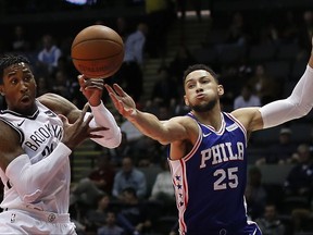 Brooklyn Nets forward Rondae Hollis-Jefferson, left, and Philadelphia 76ers guard Ben Simmons (25) reach for a rebound during the first quarter of a preseason NBA basketball game, Wednesday, Oct. 11, 2017, in Uniondale, N.Y. (AP Photo/Julie Jacobson)