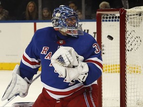 New York Rangers goalie Henrik Lundqvist (30) looks back as the puck, shot by Pittsburgh Penguins left wing Carl Hagelin, bounces out of the net on a goal during the first period of an NHL hockey game game, Tuesday, Oct. 17, 2017, in New York. (AP Photo/Julie Jacobson)