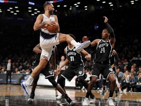 Orlando Magic guard Evan Fournier (10) passes off the ball against Brooklyn Nets forward Rondae Hollis-Jefferson (24) during the second quarter of an NBA basketball game, Friday, Oct. 20, 2017, in New York. (AP Photo/Julie Jacobson)