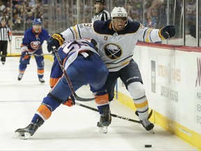 New York Islanders defenseman Johnny Boychuk (55) collides with Buffalo Sabres left wing Evander Kane (9) during the first period of a hockey game, Saturday, Oct. 7, 2017, in New York. (AP Photo/Julie Jacobson)