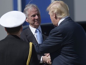 FILE- In this Feb. 17, 2017, file photo, President Donald Trump shakes hands with South Carolina Gov. Henry McMaster after arriving on Air Force One at Charleston International Airport in North Charleston, S.C. Fresh off the Alabama defeat of his chosen candidate to replace Jeff Sessions, Trump is again wading into southern horse-race politics, visiting South Carolina on Monday, Oct. 16, to lend his support for the campaign of McMaster, one of his earliest backers.  (AP Photo/Susan Walsh, File)