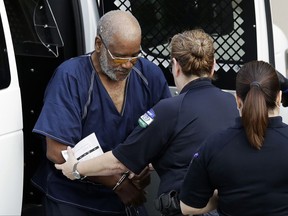 FILE- In this July 24, 2017, file photo, James Matthew Bradley Jr., left, arrives at the federal courthouse for a hearing in San Antonio. Bradley, the driver of a semitrailer packed with almost three dozen immigrants, pleaded guilty on Monday, Oc. 16, to making the deadly smuggling run. He faces up to life imprisonment. (AP Photo/Eric Gay, File)