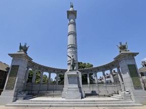 FILE- This June 28, 2017, file photo shows a statue of Confederate president Jefferson Davis on Monument Avenue in Richmond, Va. Two Confederate monuments in two Virginia cities have been vandalized this week. The Richmond Times-Dispatch reports the word "racist" was found painted in red on the Jefferson Davis statue on Tuesday, Oct. 17. (AP Photo/Steve Helber, File)