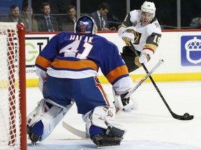 Vegas Golden Knights right wing Reilly Smith (19) takes a shot with New York Islanders goalie Jaroslav Halak (41) in the crease during the first period of an NHL hockey game in New York, Monday, Oct. 30, 2017. (AP Photo/Kathy Willens)