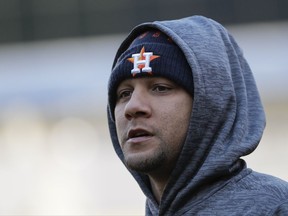 Houston Astros' Yuli Gurriel tries to stay warm during batting practice before Game 4 of baseball's American League Championship Series against the New York Yankees Tuesday, Oct. 17, 2017, in New York. (AP Photo/David J. Phillip)