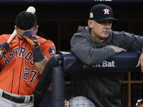 Houston Astros manager A.J. Hinch watches as Jose Altuve waits to bat during the third inning of Game 5 of baseball's American League Championship Series against the New York Yankees Wednesday, Oct. 18, 2017, in New York. (AP Photo/David J. Phillip)