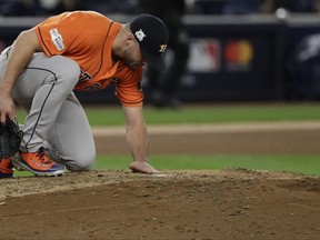 Houston Astros starting pitcher Lance McCullers Jr. looks over the mound after breaking a diamond necklace during the fourth inning of Game 4 of baseball's American League Championship Series New York Yankees Tuesday, Oct. 17, 2017, in New York. (AP Photo/David J. Phillip)