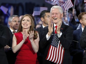 FILE - In this Thursday, July 28, 2016 file  photo, Chelsea Clinton and former President Bill Clinton applaud as Democratic presidential nominee Hillary Clinton speaks during the final day of the Democratic National Convention in Philadelphia. Hundreds of college students from across the U.S. will be coming to Boston for a leadership conference created by former President Bill Clinton. Northeastern University is hosting the 10th annual Clinton Global Initiative University meeting on Friday, Oct. 13, 2017, which gathers students and experts in a variety of fields to discuss solutions to pressing problems. (AP Photo/Carolyn Kaster, File)