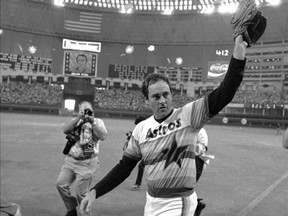FILE - This Sept. 26, 1981, file photo shows Houston Astros' Nolan Ryan waving to the crowd after pitching his fifth career no-hitter, defeating the Los Angeles Dodgers, 5-0, as the Astrodome scoreboard explodes with fireworks in the background in Houston. The 2017 baseball season has in many ways been defined by the dominance of three teams. The dominance of the Astros, Dodgers and Cleveland Indians raised a fun question: What was the best team in the history of those franchises? The AP took a shot at answering this for every team in baseball, creating a timeline of greatness spanning over a century. (AP Photo/Tim Johnson, File)