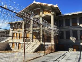 FILE- In this March 3, 2017 file photo, razor wire is coiled along a fence at the closed Mount McGregor Correctional Facility in Wilton, N.Y. Empire State Development said said Tuesday, Oct. 24, 2017 it has halted efforts to sell the former prison site for redevelopment after the three proposals that were received since the state put the site out for bid in January 2017 were rejected as unfeasible. (AP Photo/Chris Carola)