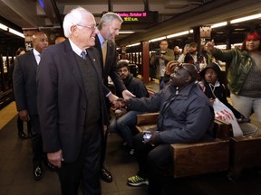 Independent U.S. Sen. Bernie Sanders, left, and New York Mayor Bill de Blasio, meet commuters before they ride a New York City subway, as Sanders campaigns with de Blasio ahead of the Nov. 7 mayoral election, Monday, Oct. 30, 2017. (AP Photo/Richard Drew)