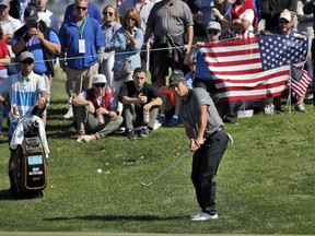 International Team member Hideki Matsuyama hits to the third green during the final round of the Presidents Cup at Liberty National Golf Club in Jersey City, N.J., Sunday, Oct. 1, 2017. (AP Photo/Julio Cortez)