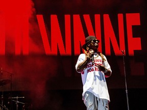 FILE - Lil Wayne performs at the Lil' WeezyAna Fest at Champions Square on Friday, Aug. 25, 2017, in New Orleans. Fans of rapper Lil Wayne will be offered refunds after the recording artist on Saturday, Sept. 30, 2017 refused to pass through a security check to enter the Colonial Life Arena in Columbia, and skipped the concert.  (Photo by Amy Harris/Invision/AP, File)