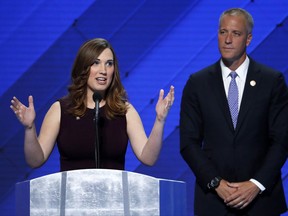 FILE - In this July 28, 2016 file photo, LGBT rights activist Sarah McBride speaks as Rep. Sean Patrick Maloney, D-NY, Co-Chair of the Congressional LGBT Equality Caucus listens during the final day of the Democratic National Convention in Philadelphia. Former vice president Joe Biden is writing the foreword to a memoir by transgender activist McBride, who made history when she addressed the Democratic National Convention last year. (AP Photo/J. Scott Applewhite, File)