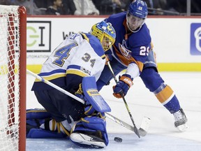 St. Louis Blues goalie Jake Allen, left, defends the goal from New York Islanders' Brock Nelson during the second period of an NHL hockey game, Monday, Oct. 9, 2017, in New York. (AP Photo/Seth Wenig)