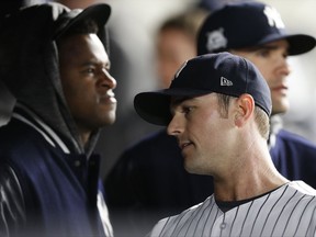 New York Yankees starting pitcher Luis Severino, left, watches the game as relief pitcher David Robertson reacts after Yankees manager Joe Girardi removed him with a Minnesota Twins runner on base and Joe Mauer batting, during the sixth inning of the American League wild-card playoff baseball game in New York, Tuesday, Oct. 3, 2017. (AP Photo/Kathy Willens)