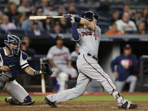 Minnesota Twins' Joe Mauer flies out to left with runners on first and second during the sixth inning of the American League wild-card playoff baseball game against the New York Yankees in New York, Tuesday, Oct. 3, 2017. Yankees catcher Gary Sanchez is at left. (AP Photo/Kathy Willens)