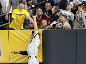 New York Yankees right fielder Aaron Judge makes a catch at the wall on a line drive hit by Cleveland Indians' Francisco Lindor during the sixth inning in Game 3 of baseball's American League Division Series, Sunday, Oct. 8, 2017, in New York. (AP Photo/Kathy Willens)