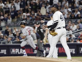 New York Yankees starting pitcher Luis Severino waits as Minnesota Twins' Eddie Rosario (20) runs the bases after hitting a two-run home run during the first inning of the American League wild-card baseball playoff game Tuesday, Oct. 3, 2017, in New York. (AP Photo/Frank Franklin II)