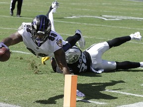Baltimore Ravens wide receiver Vince Mayle (88) scores a touchdown past Oakland Raiders strong safety Keith McGill II during the first half of an NFL football game in Oakland, Calif., Sunday, Oct. 8, 2017. (AP Photo/Ben Margot)