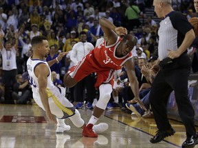 Houston Rockets' Chris Paul, right, steps over Golden State Warriors' Stephen Curry (30) after losing the ball out of bounds during the first quarter of an NBA basketball game Tuesday, Oct. 17, 2017, in Oakland, Calif. (AP Photo/Ben Margot)