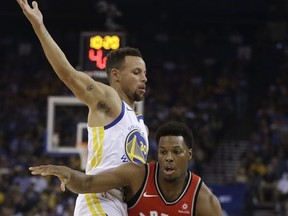 Toronto Raptors' Kyle Lowry (7) drives the ball around Golden State Warriors' Stephen Curry, left, during the first half of an NBA basketball game Wednesday, Oct. 25, 2017, in Oakland, Calif. (AP Photo/Ben Margot)