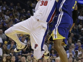 Detroit Pistons' Jon Leuer, left, shoots against Golden State Warriors' David West during the first half of an NBA basketball game, Sunday, Oct. 29, 2017, in Oakland, Calif. (AP Photo/Ben Margot)