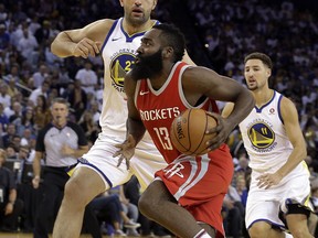 Houston Rockets' James Harden (13) drives the ball against Golden State Warriors' Zaza Pachulia, left, during the first quarter of an NBA basketball game Tuesday, Oct. 17, 2017, in Oakland, Calif. (AP Photo/Ben Margot)