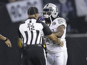 Oakland Raiders running back Marshawn Lynch (24) makes contact with back judge Greg Steed (12) during the first half of an NFL football game between the Raiders and the Kansas City Chiefs in Oakland, Calif., Thursday, Oct. 19, 2017. Lynch was ejected after the play. (AP Photo/Ben Margot)