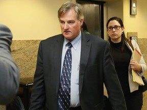 In this June 30, 2017 file photo, ex-Tulsa police officer Shannon Kepler, left, arrives with his legal team for afternoon testimony in his third trial in Tulsa, Okla. Jurors in the fourth murder trial for Kepler, a white former Oklahoma police officer, heard a 911 call Tuesday, Oct. 17, 2017 where his daughter screams to dispatchers that her father had shot her 19-year-old black boyfriend.