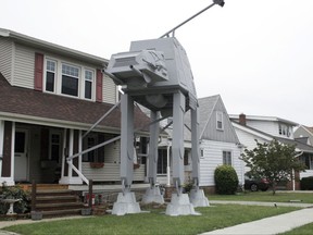 This Thursday, Oct. 12, 2017 photo shows a replica four-legged All Terrain Armored Transport, or AT-AT walker in Parma, Ohio. Owner Nick Meyer tells Cleveland.com he used wood, hard foam and plastic barrels. He says he enjoys the "Star Wars" movies but isn't a fanatic and simply thought the display would be unique. (Patrick Cooley/The Plain Dealer-Cleveland.com via AP)